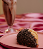 A crispy, golden-brown croissant dipped in chocolate, served on a plate for home delivery in Pokhara.
