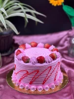 Slice of three-layer strawberry cake in Pokhara with fresh berries and cream frosting