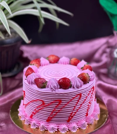 Slice of three-layer strawberry cake in Pokhara with fresh berries and cream frosting