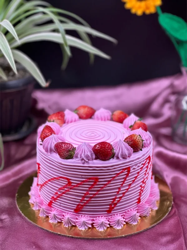 Slice of three-layer strawberry cake in Pokhara with fresh berries and cream frosting
