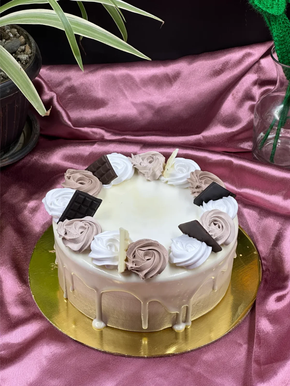 Whole three-layer chocolate cake with glossy chocolate ganache drip and chocolate decorations