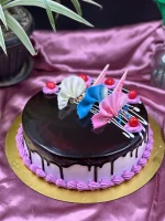 Whole chocolate truffle cake with mirror glaze finish and chocolate curls
