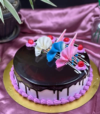 Whole chocolate truffle cake with mirror glaze finish and chocolate curls