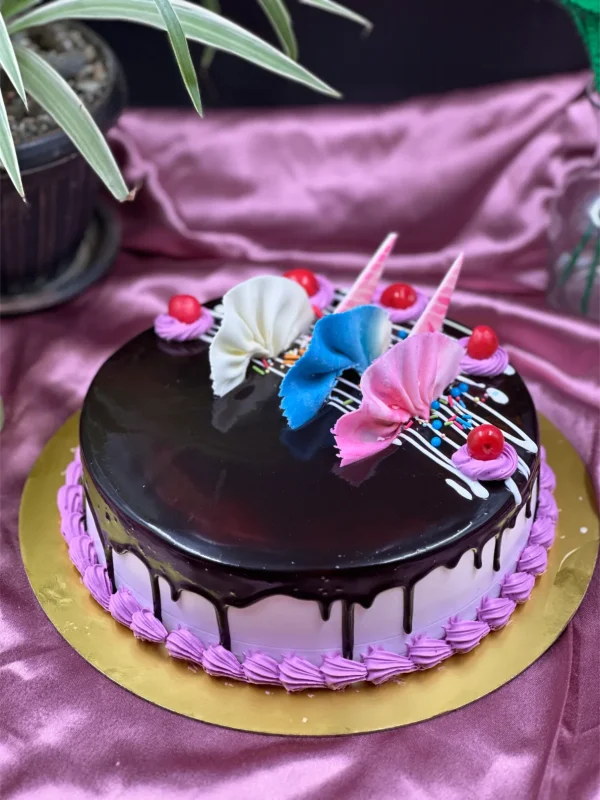 Whole chocolate truffle cake with mirror glaze finish and chocolate curls