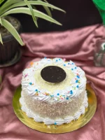 Slice of White Forest cake in Pokhara showing vanilla sponge, cherry compote, and white chocolate mousse