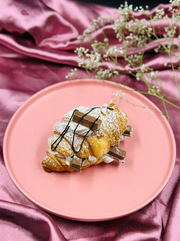 Kitkat Croissant plated with extra cream, molten chocolate and kitkat chunks